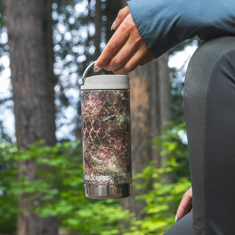 12oz-tkwide-with-cafe-cap-mossy-oak-n1 12oz_tumbler_mossyoak_rainbowtrout_hand_closeup_square.jpg