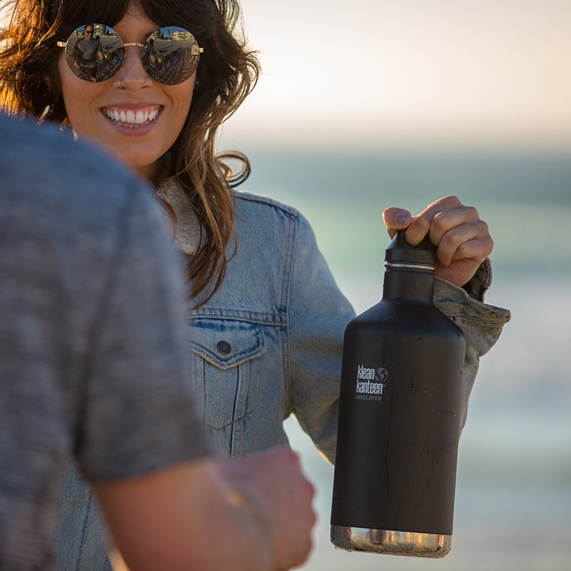 64oz-classic-with-loop-cap-q4 64oz_insulated_classic_black_beach_girl_hand_square.jpg